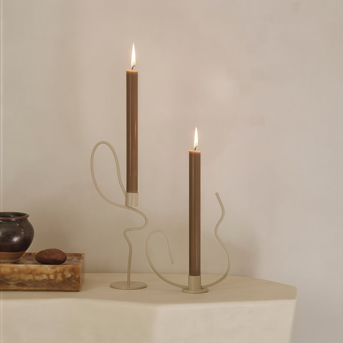 Dancer-Themed Floor-Standing Candle Holder in pale metal, with flowing dancer-like curves and two tall candle stems.