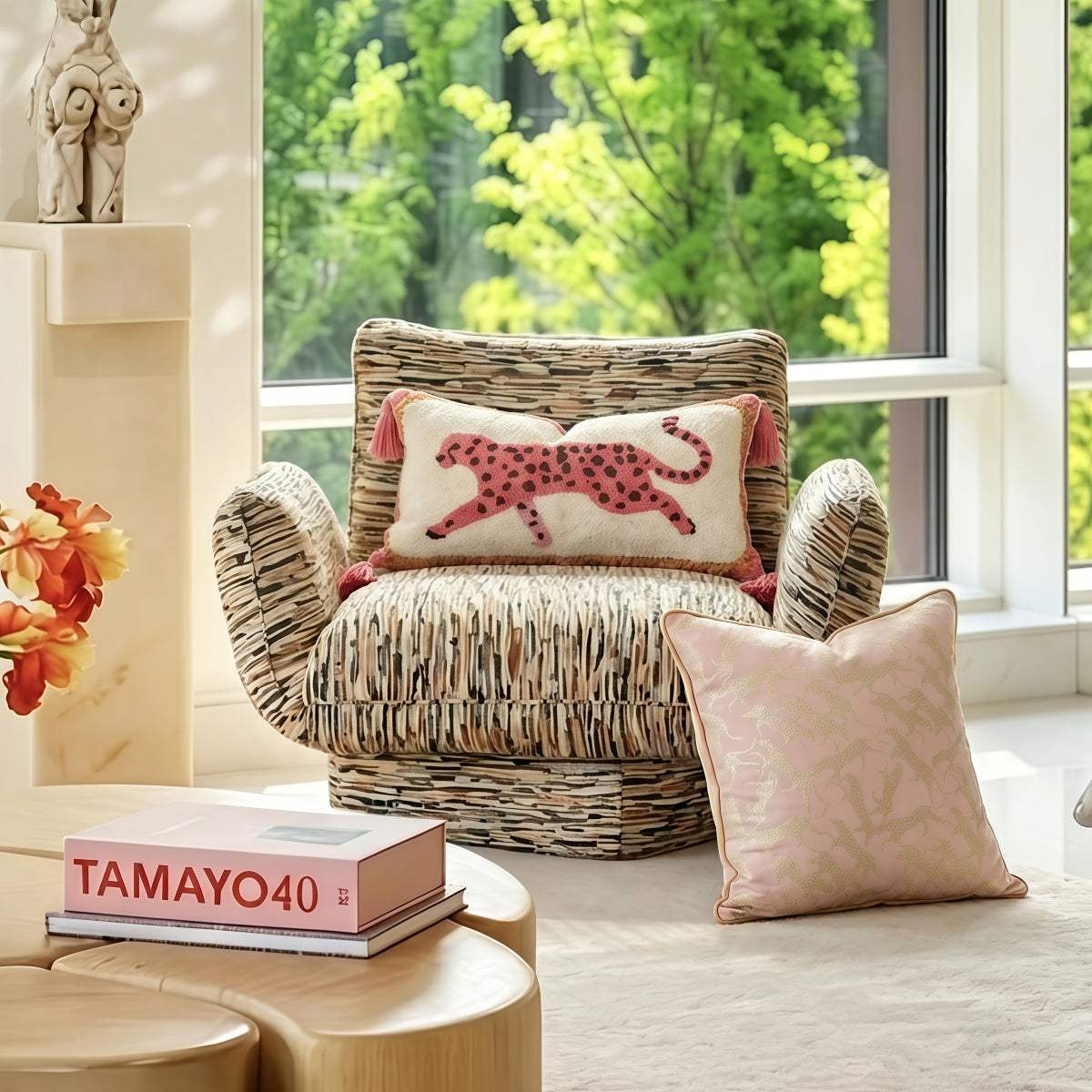 French-Style Pink Leopard-Pattern lumbar pillow in cream boucle fabric, with a pink spotted leopard motif and tassel corners.