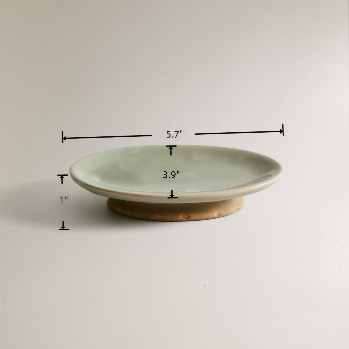 Ceramic soap dish in the Vintage Green Crackle-Glaze Ceramic Set, pale green with a raised bronze-toned base.