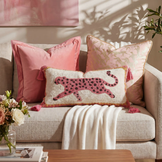 French-Style Pink Leopard-Pattern lumbar throw pillow in cream boucle, featuring a pink spotted leopard motif and tassel trim.