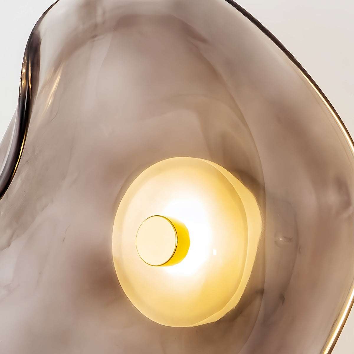 Round minimalist wall sconce with wrought iron frame and translucent glass shade in warm LED light for bedroom and living room