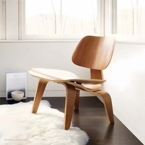 Timeless molded plywood Lounge Wood Chair in walnut finish with black accents in a modern room setting