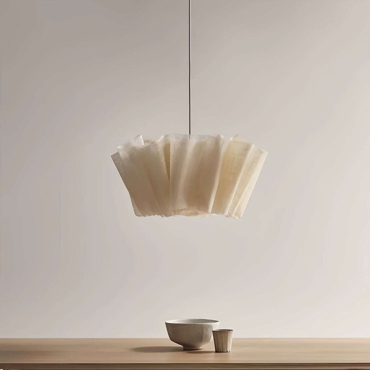 Minimalist pendant light with hand-woven natural fiber shade and metal ceiling base for warm ambient lighting