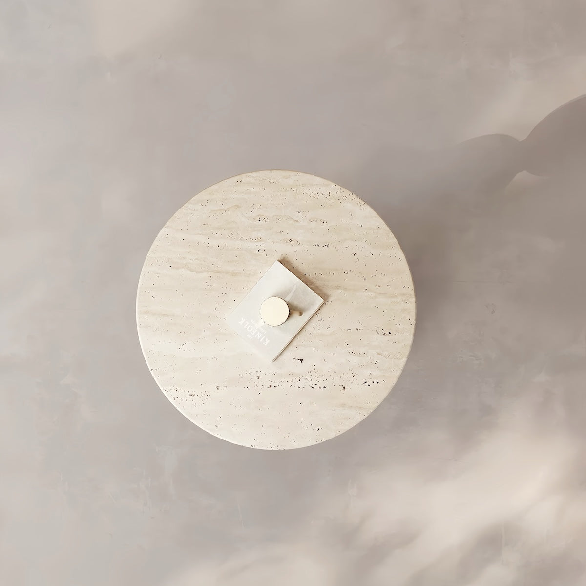 Modern round accent table with yellow travertine top and stainless steel sphere base