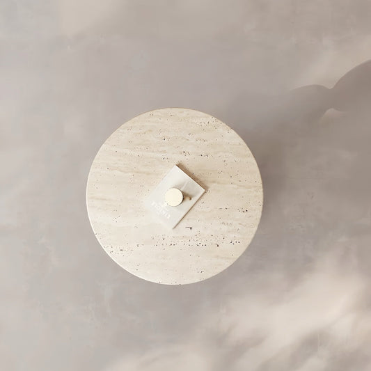 Modern round accent table with yellow travertine top and stainless steel sphere base