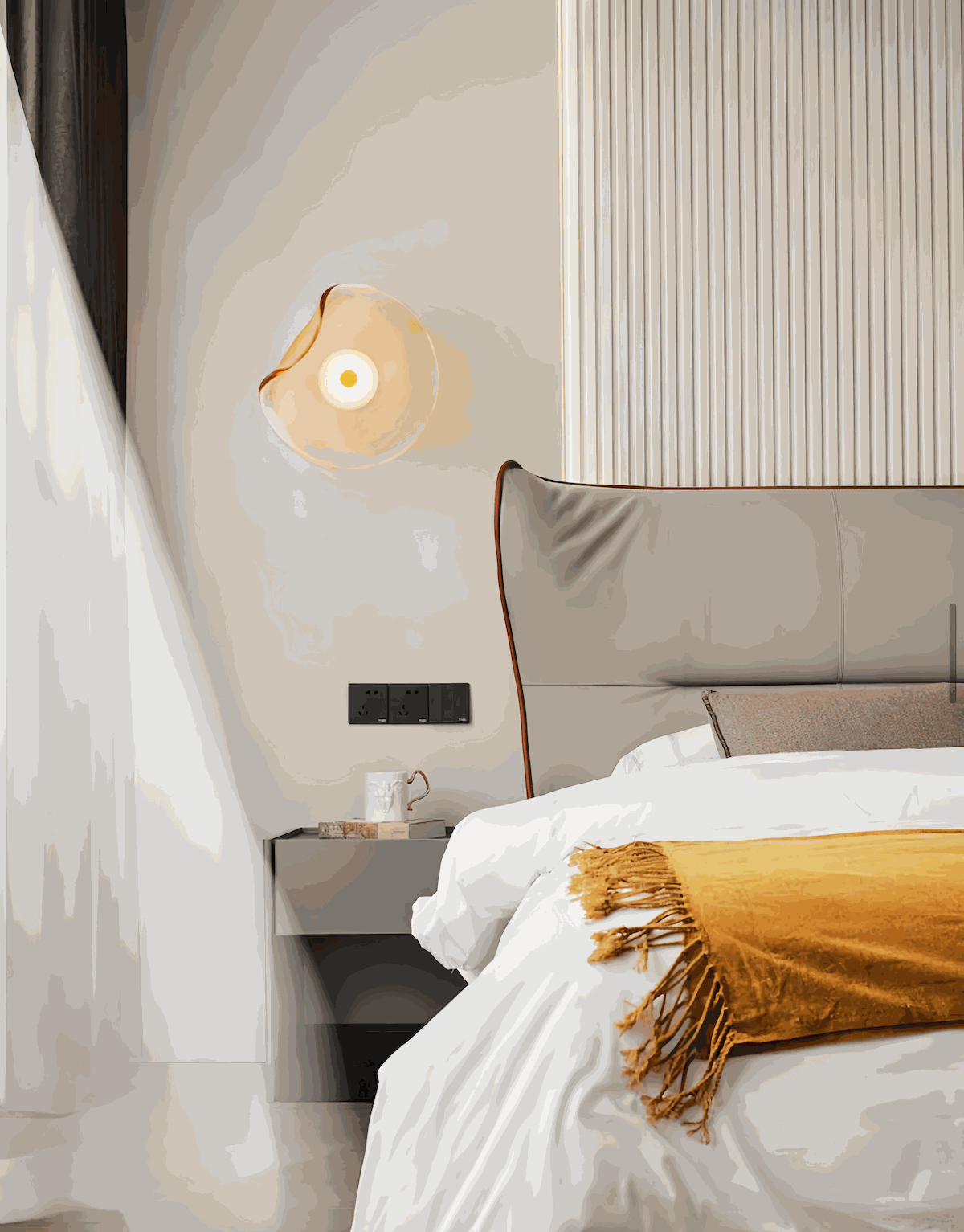 Round minimalist wall sconce with wrought iron frame and translucent glass shade in smoke and amber colors, emitting warm 5W LED light.