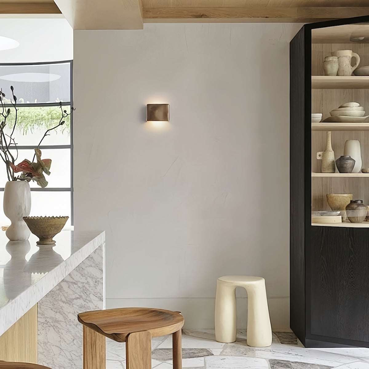 Scape Wall Light aluminum natural finish mounted on indoor wall with warm light in modern minimalist room