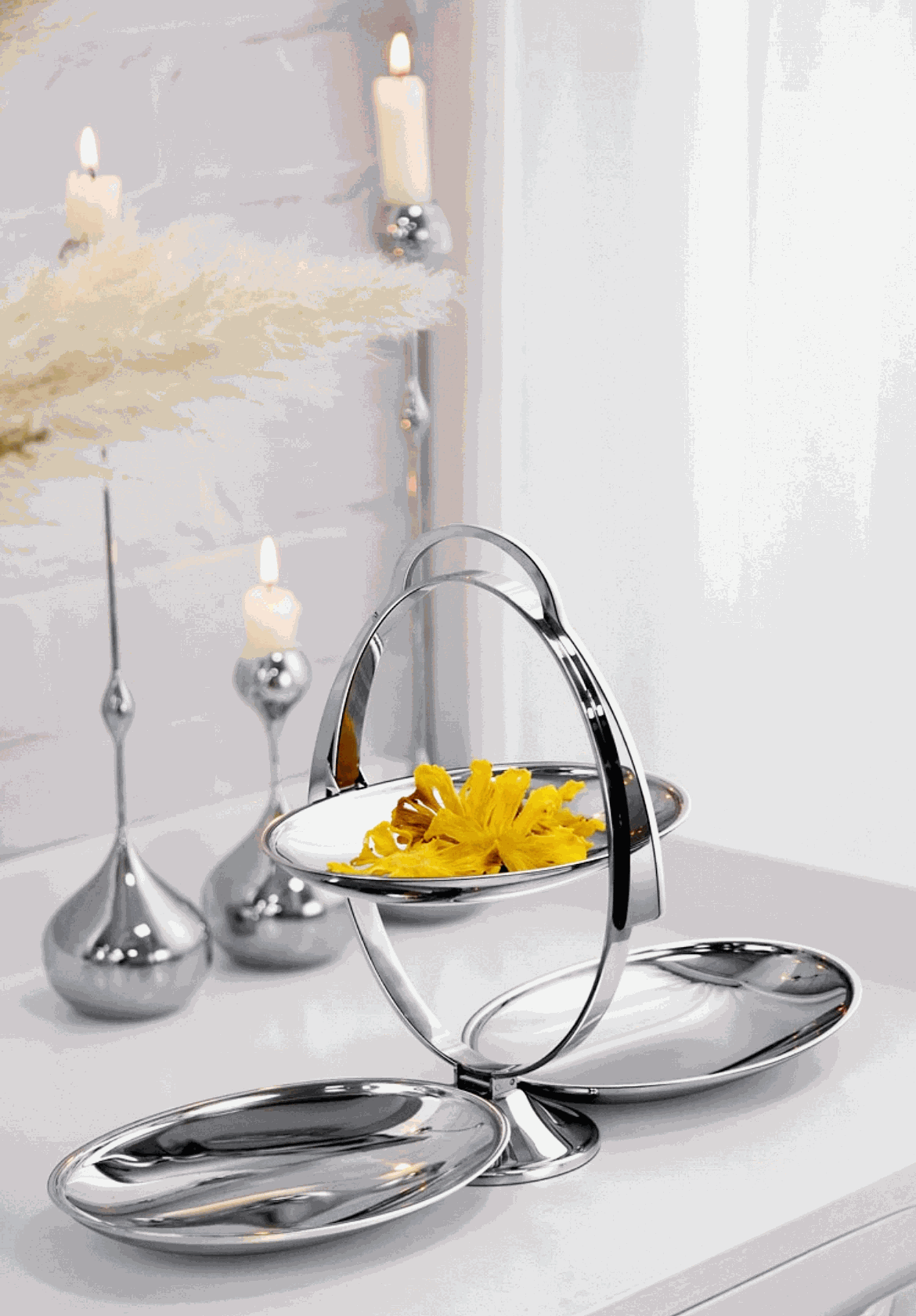Foldable 3-tier stainless steel fruit platter with mirror finish on dining table