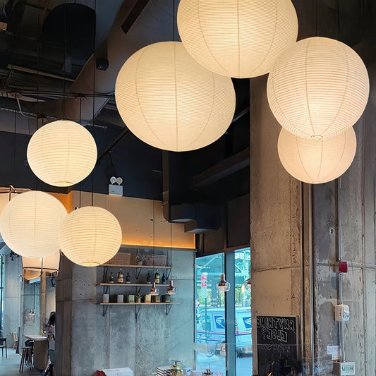 Noguchi Isamu rice paper pendant lighting fixture illuminating room