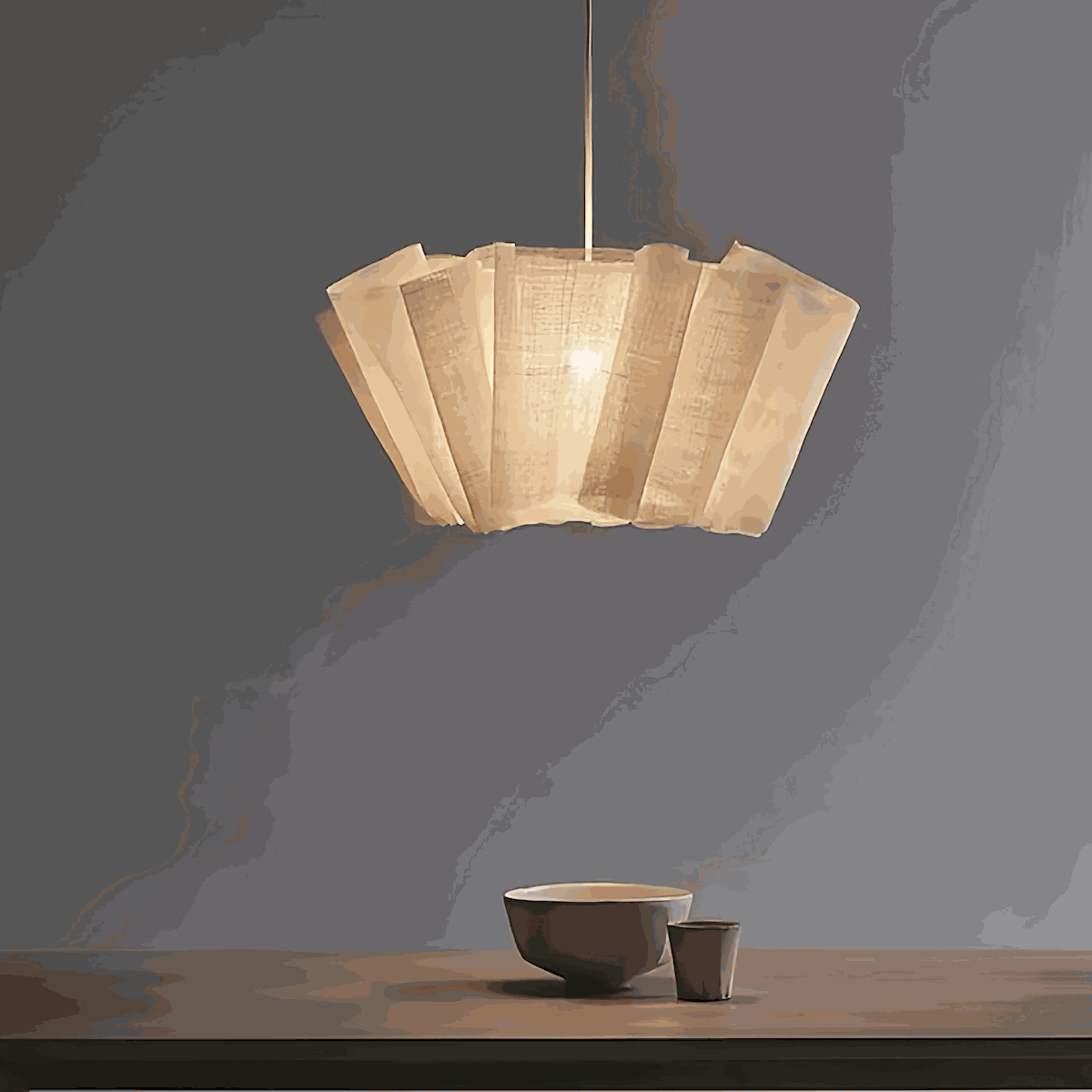 Minimalist pendant light with natural plant fiber shade and metal ceiling base illuminating warm light in modern dining room