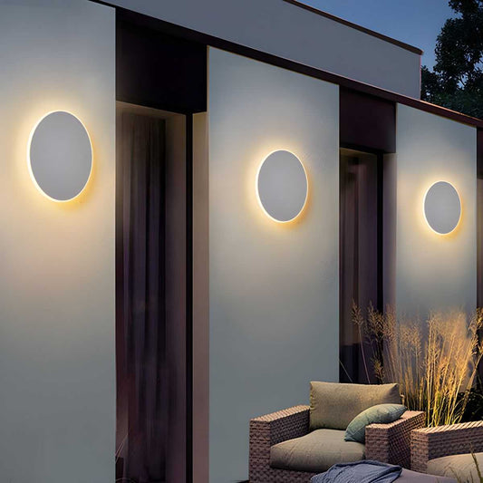 Modern Style Round LED outdoor wall lighting on exterior patio walls at night