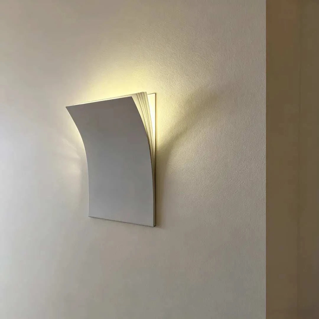 Minimalist book-shaped wall sconce with matte metal finish and warm white LED light for modern living rooms, hallways, and hotel decor