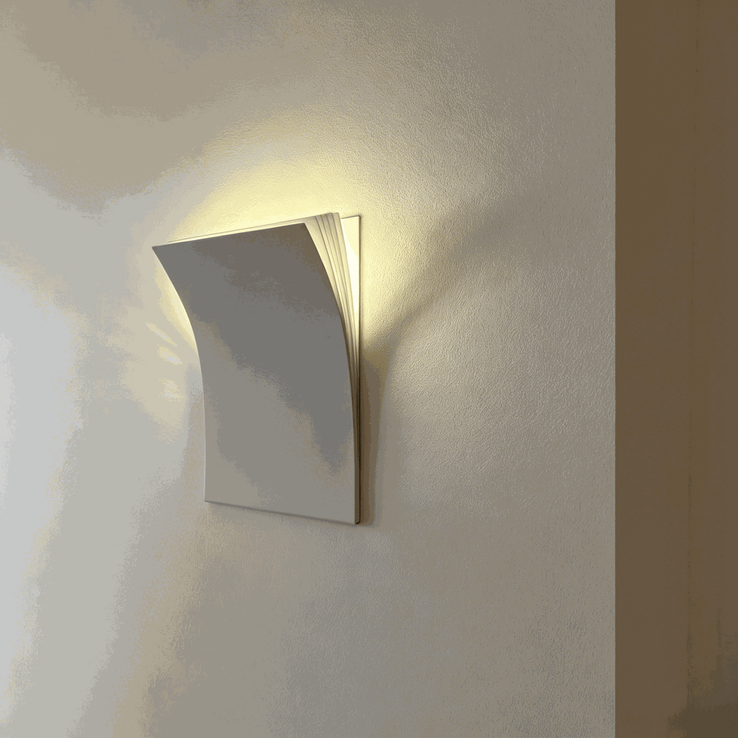 Book-shaped matte metal wall sconce with warm white LED light for minimalist modern decor in living rooms and hallways