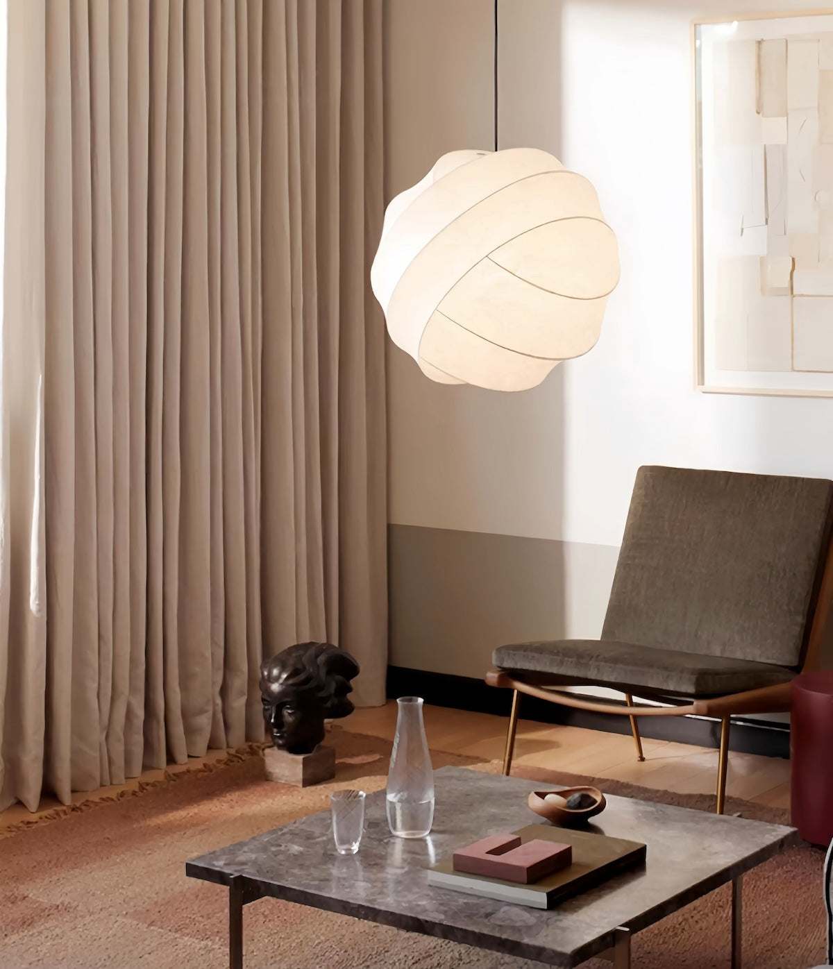 Modern Wabi-Sabi silk pendant light with hand-crafted silk lampshade casting warm, diffused glow in minimalist dining room setting