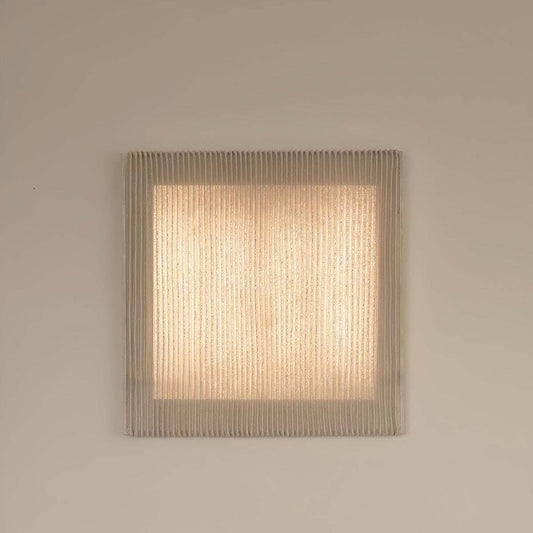 Nordic modern minimalist wall sconce with warm LED light and textured stainless steel mesh shade