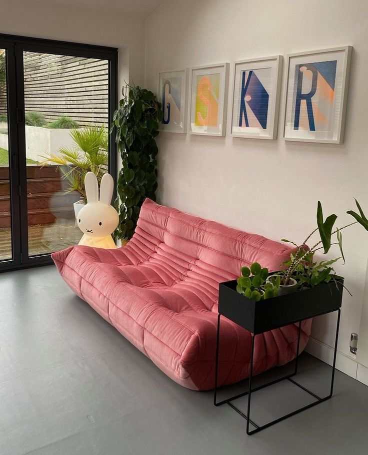 Pink corduroy Togo couch with soft, ergonomic design in modern living room setting