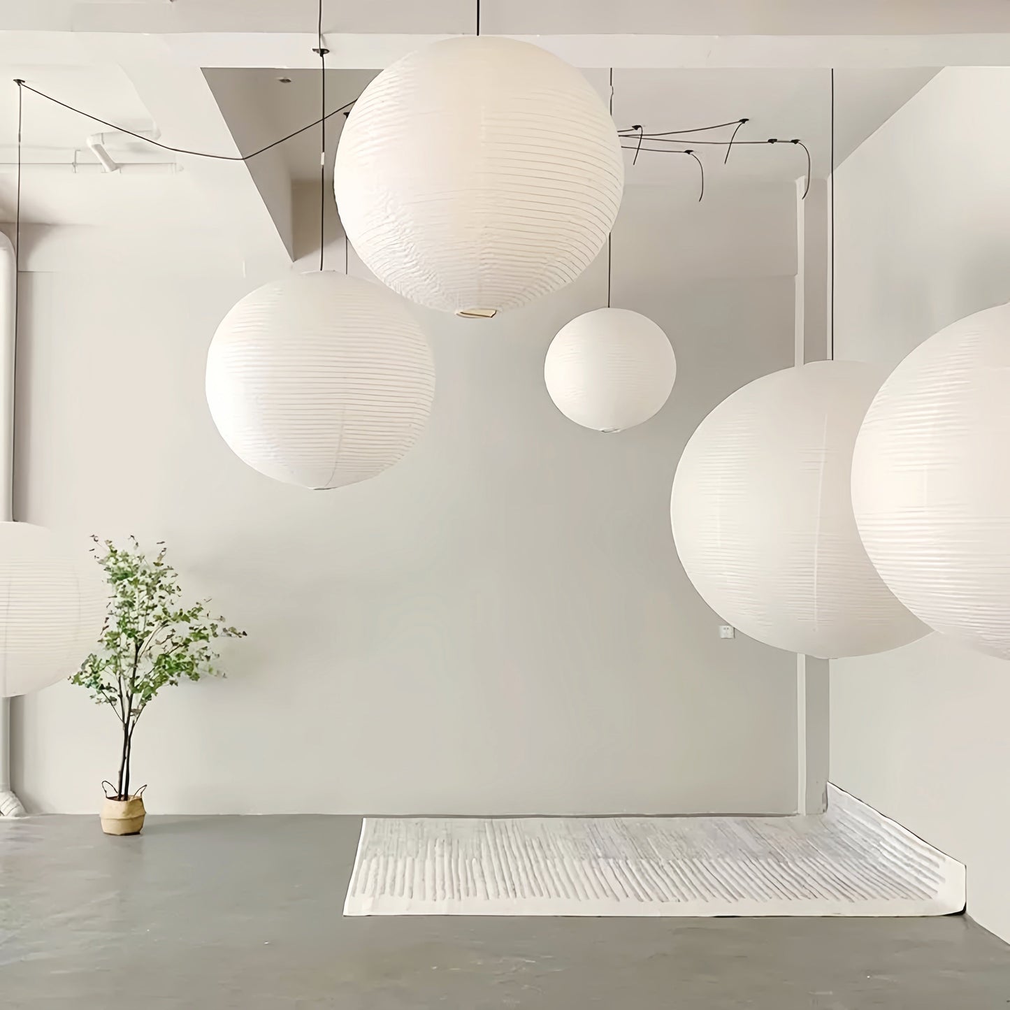Noguchi Isamu rice paper pendant lighting fixture hanging from ceiling