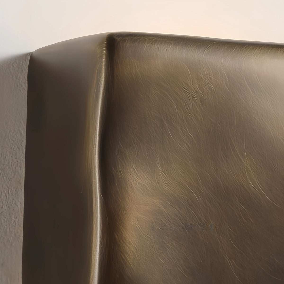 Close-up of Scape Wall Light outdoor sand-cast brass waterproof sconce with textured bronze finish