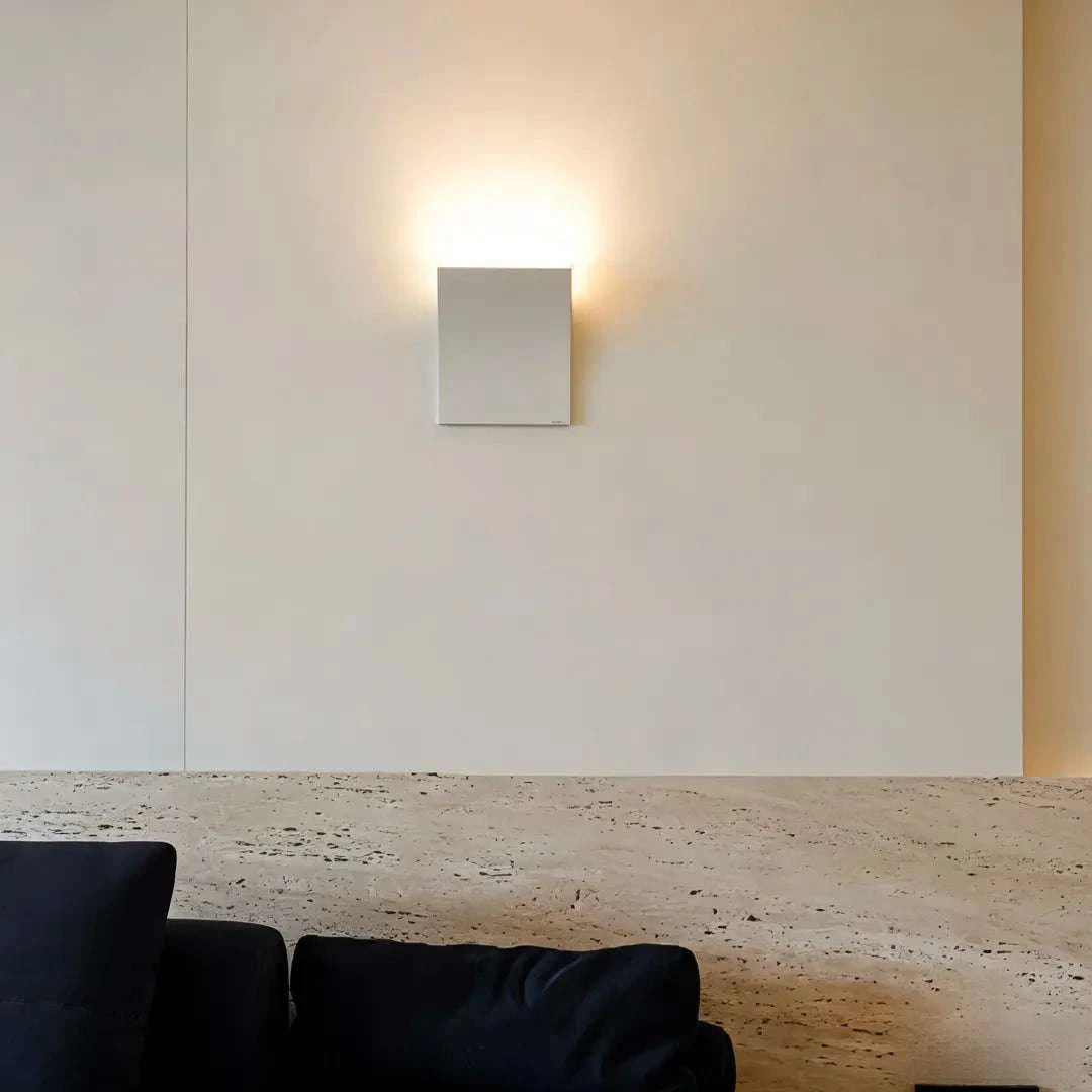 Minimalist book-shaped wall sconce with warm white LED light and matte metal finish for modern interior decor