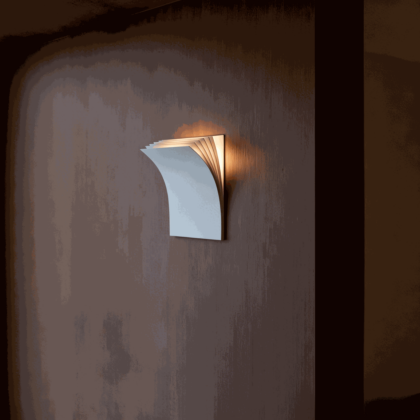 Minimalist black book-shaped wall sconce with warm LED light for modern living room and hallway decor