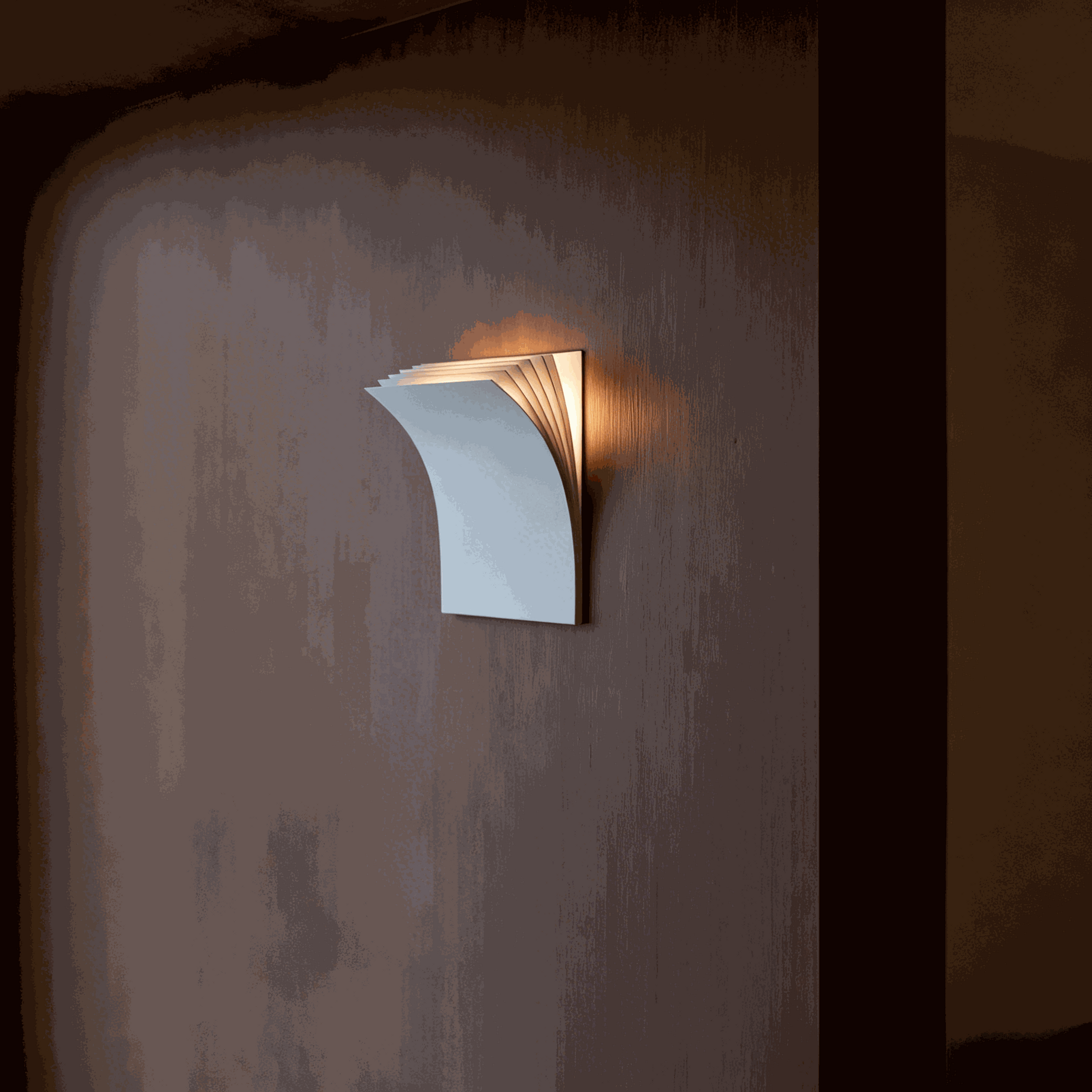 Minimalist black book-shaped wall sconce with warm LED light for modern living room and hallway decor