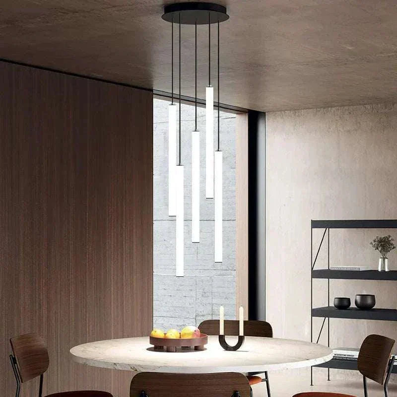 Modern long pendant lights chandelier with adjustable white metal tubes hanging above dining table in elegant interior