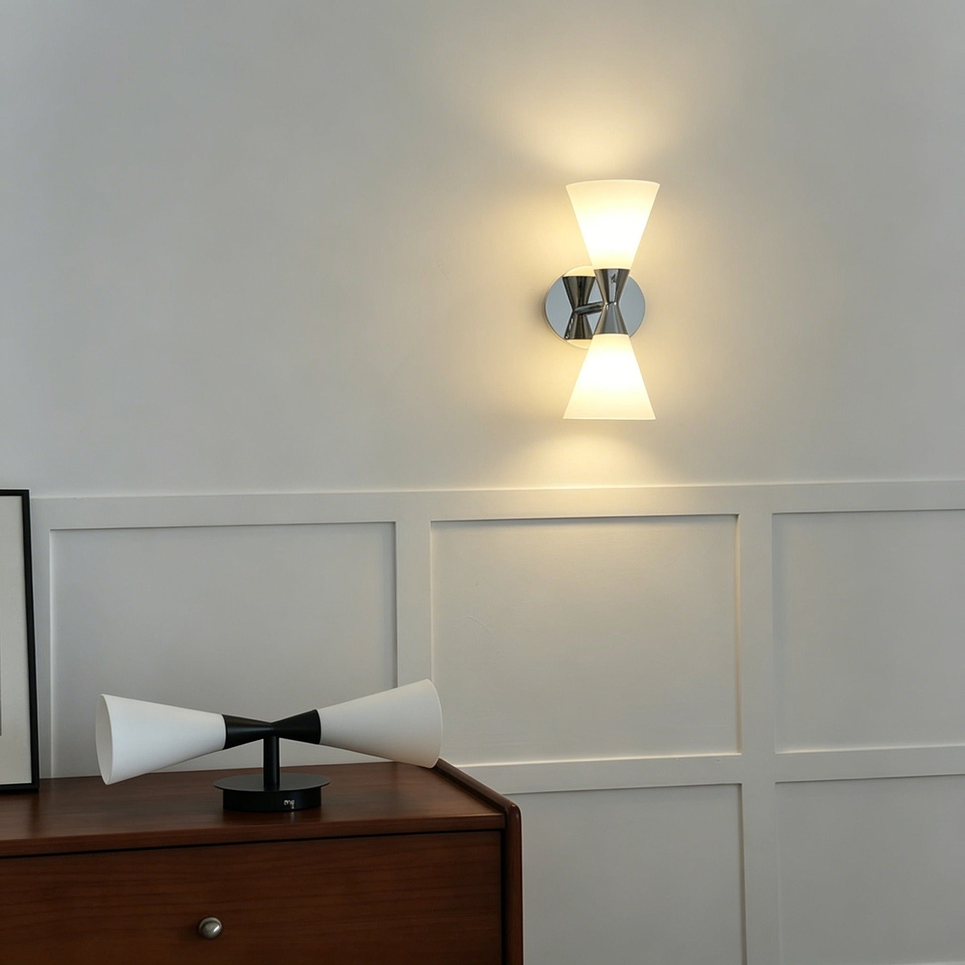 Nordic modern hourglass wall sconce with chrome-plated carbon steel body and glass shade lighting living room and bedroom