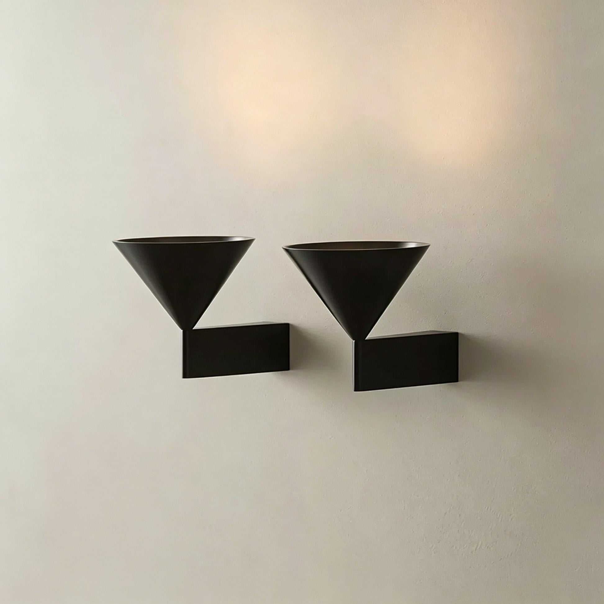 Italian minimalist modern wall sconce with conical aluminum shade and warm LED light