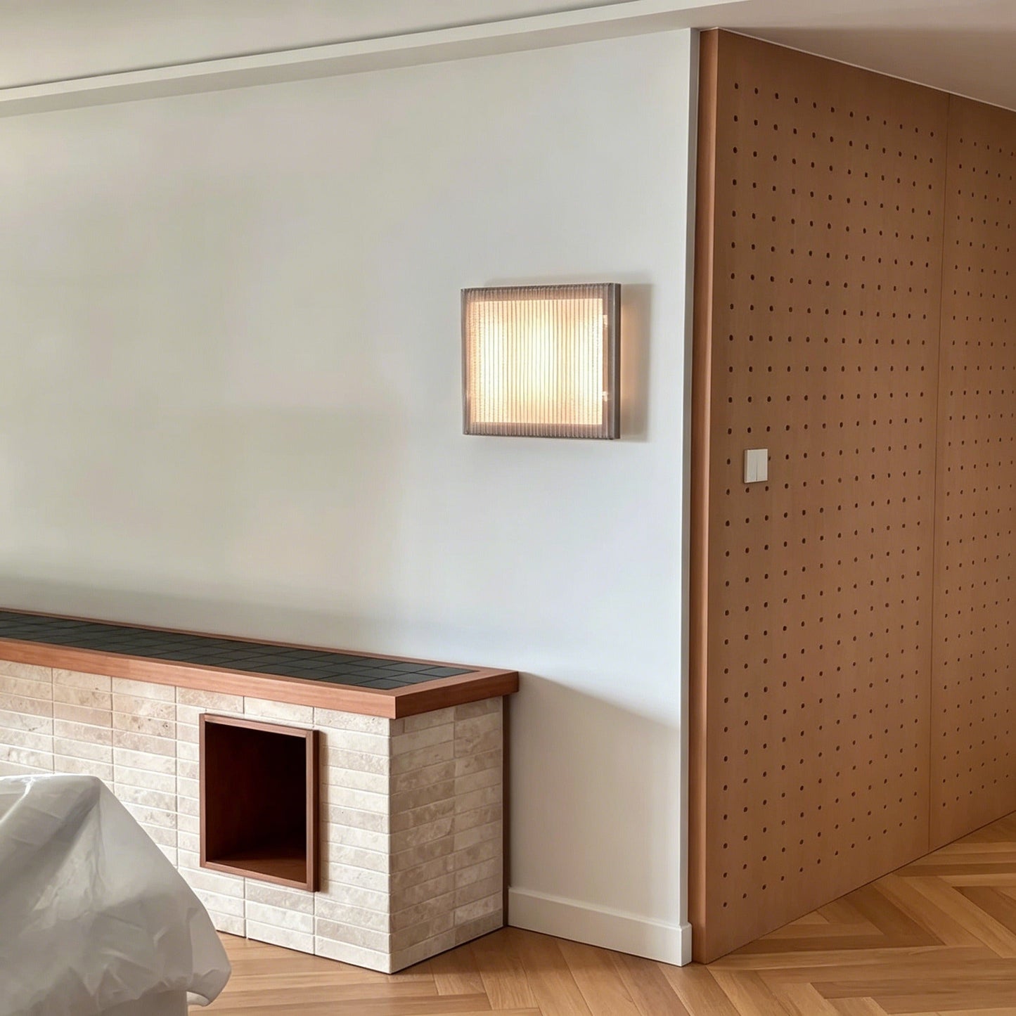 Nordic modern minimalist square wall sconce with warm full-spectrum LED light and textured stainless steel mesh shade in living room