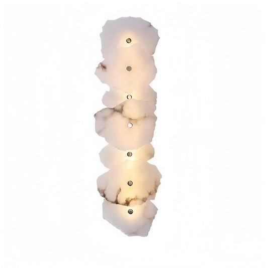 Modern marble wall light with multiple natural stone discs and copper hardware, emitting soft warm LED glow.