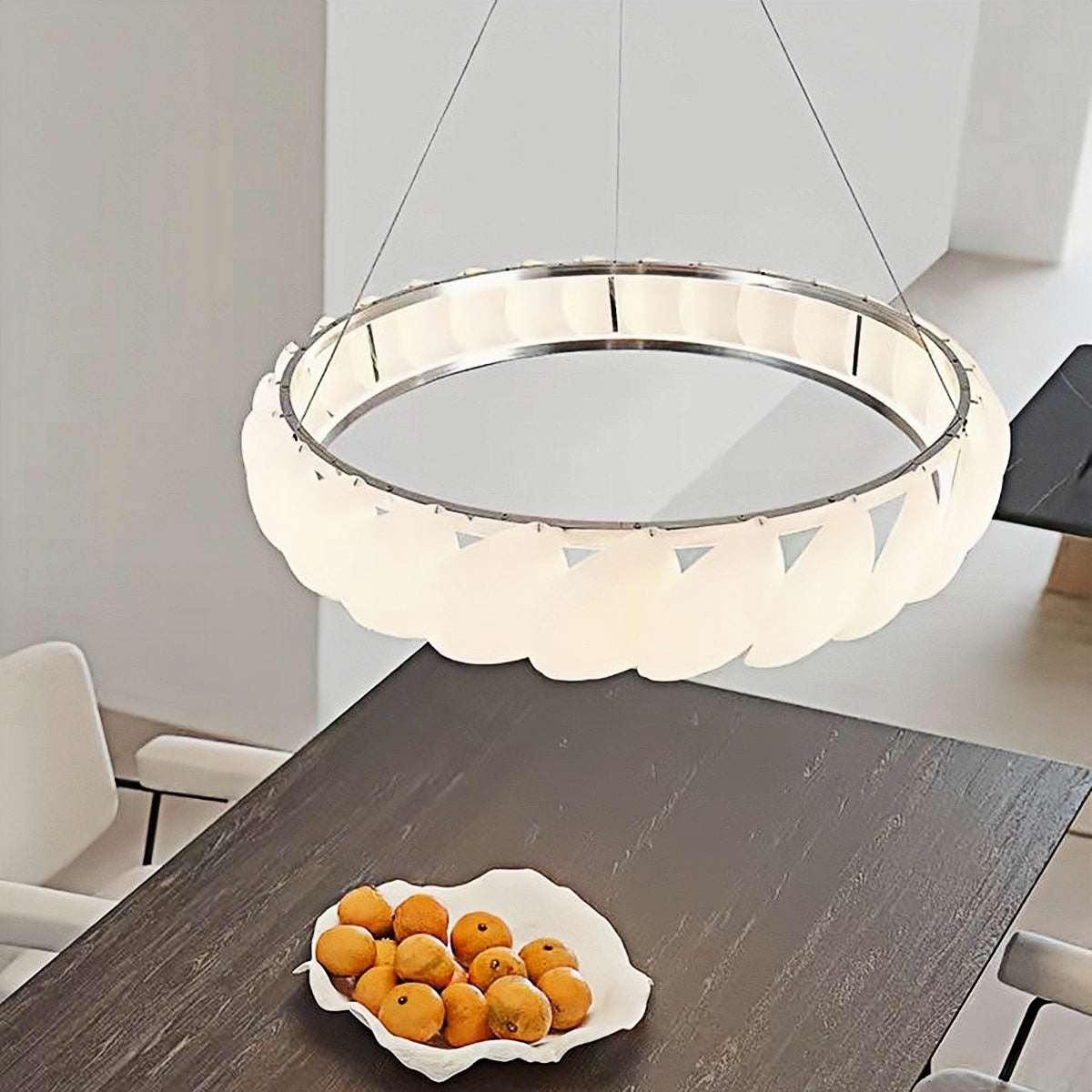 Modern ring pendant light with sleek circular design and soft LED glow over dining table