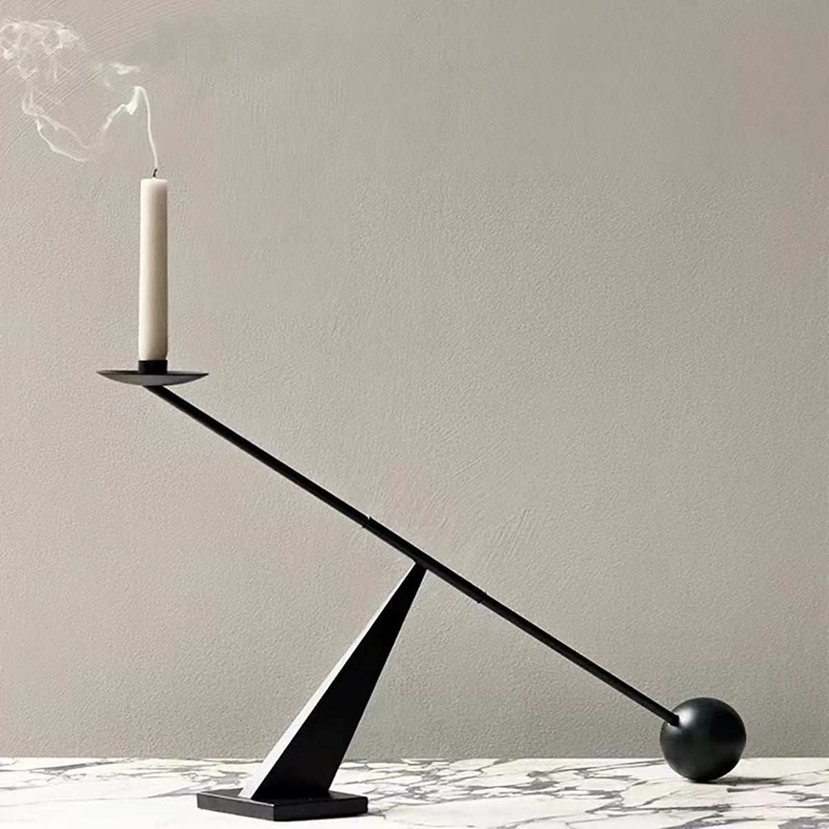 modern minimalist black candle holder with geometric wabi-sabi design on marble surface