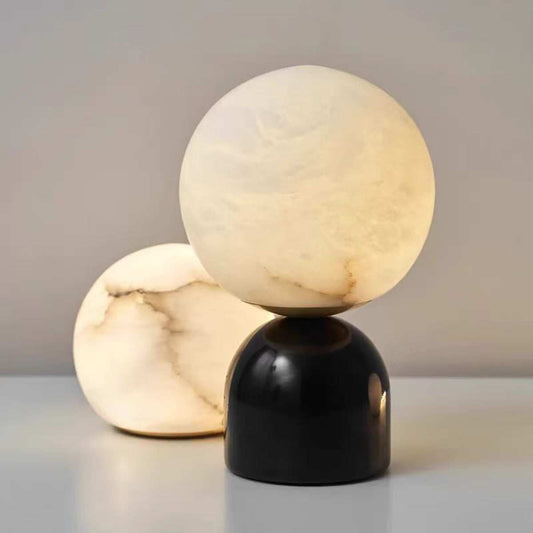 Elegant Spanish marble table lamp with black base and ambient light, available in small and large sizes