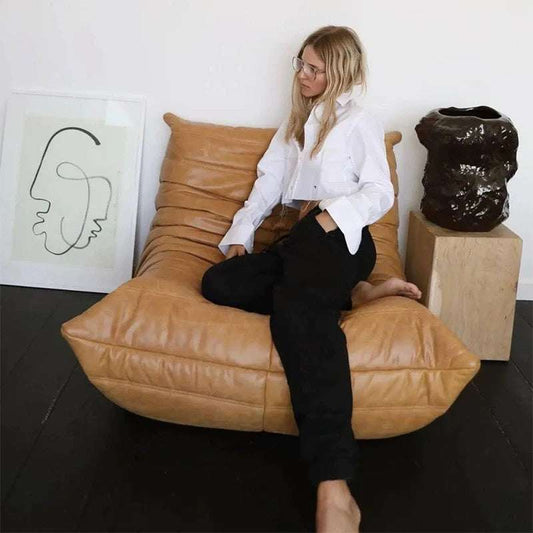 Togo Chair fiber leather replica with ergonomic design and deep cushioned seat in tan color