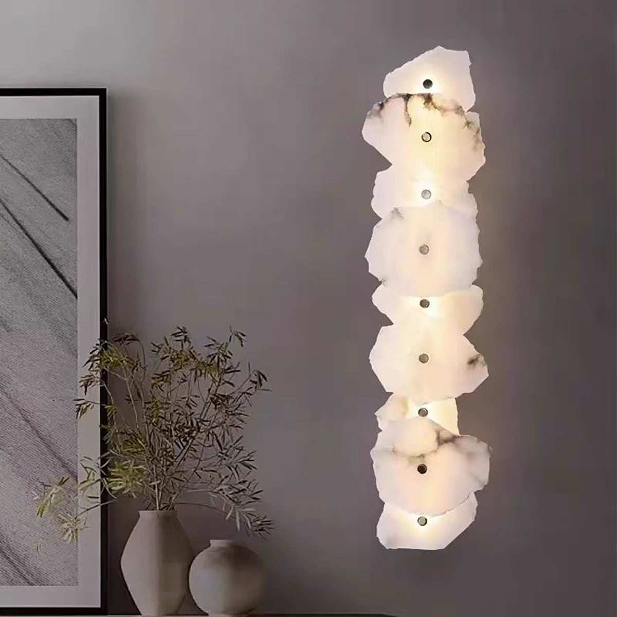 modern marble wall light with multiple natural marble discs and warm LED glow