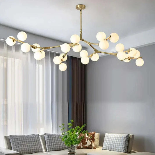 Nordic chandelier light with gold finish and frosted glass LED bulbs in modern living room