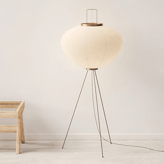 Japanese Noguchi Isamu Floor Lamp with paper shade and tripod metal base in minimalist room setting