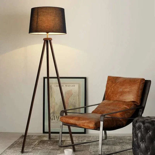 Mid Century Floor Lamp with tripod wooden base and fabric shade in stylish living room setting