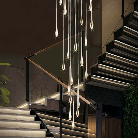 Minimalist LED chandelier with teardrop crystals hanging in modern duplex staircase lighting