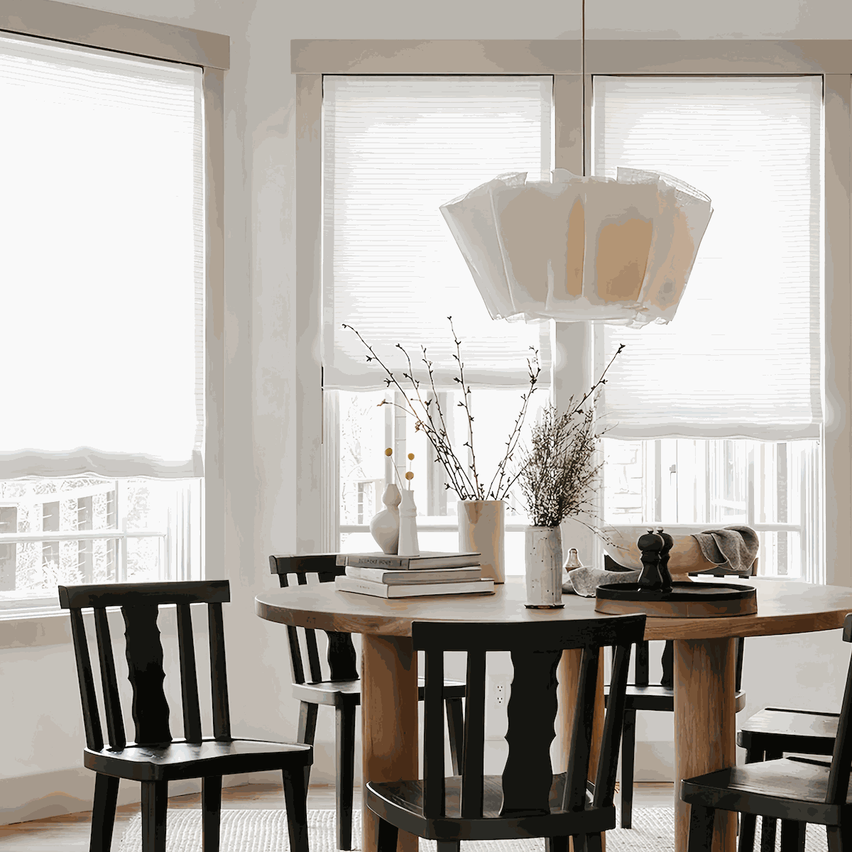 Minimalist pendant light with natural plant fiber shade and metal ceiling base hanging in modern dining room