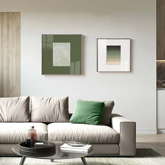 Modern living room featuring green wall art with spray painting on canvas, eco-friendly materials, and a minimalist beige sofa with a green cushion.