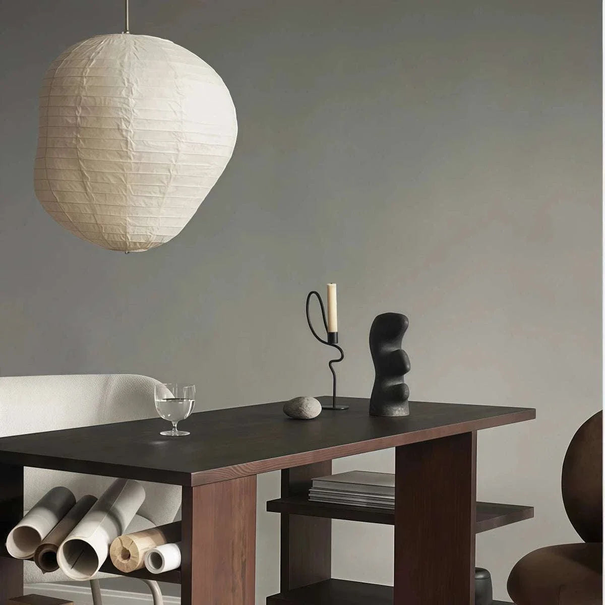 Dancer-Themed Floor-Standing Candle Holder in black iron, with a looping curved stem and slender white candle.