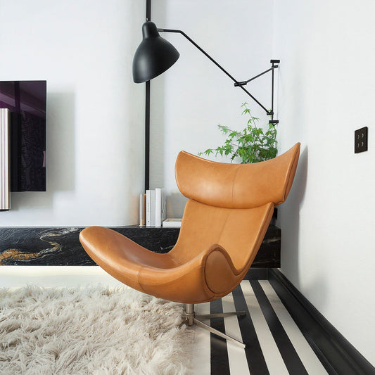 Imola Lounge Chair with Footstool in modern living room setting, showcasing Danish craftsmanship and ergonomic design.