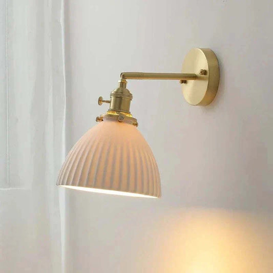 Swing arm wall light with ceramic shade and brass finish for adjustable, stylish lighting