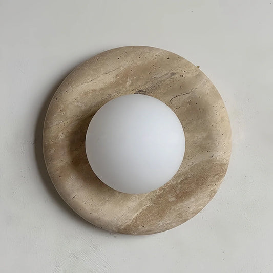 Natural travertine marble wall sconce with LED light in rustic wabi-sabi design for bedroom and hallway ambiance