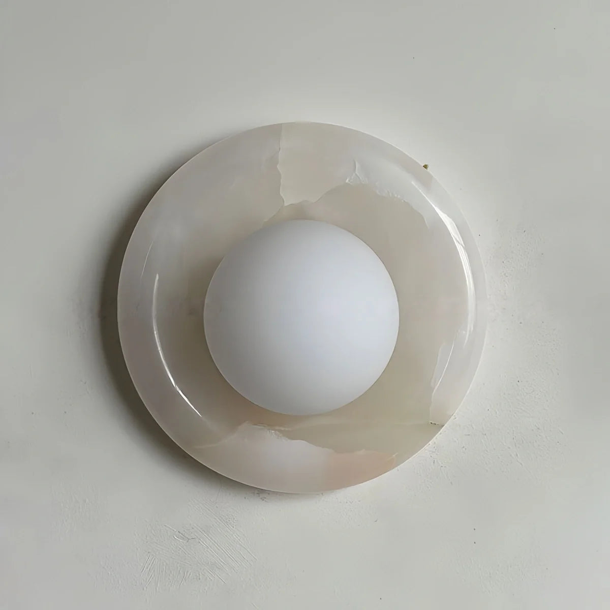 Natural travertine marble wall sconce with textured yellow stone and warm LED light for bedroom and hotel ambiance