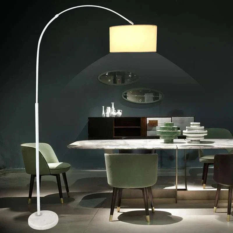 modern adjustable white LED floor lamp illuminating dining area with green chairs and decorative items