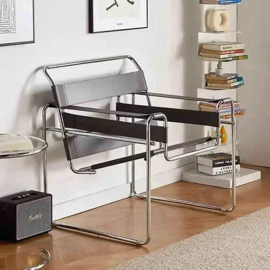 Nordic leisure chair in modern industrial style with metal frame and saddle leather in a living room setting.
