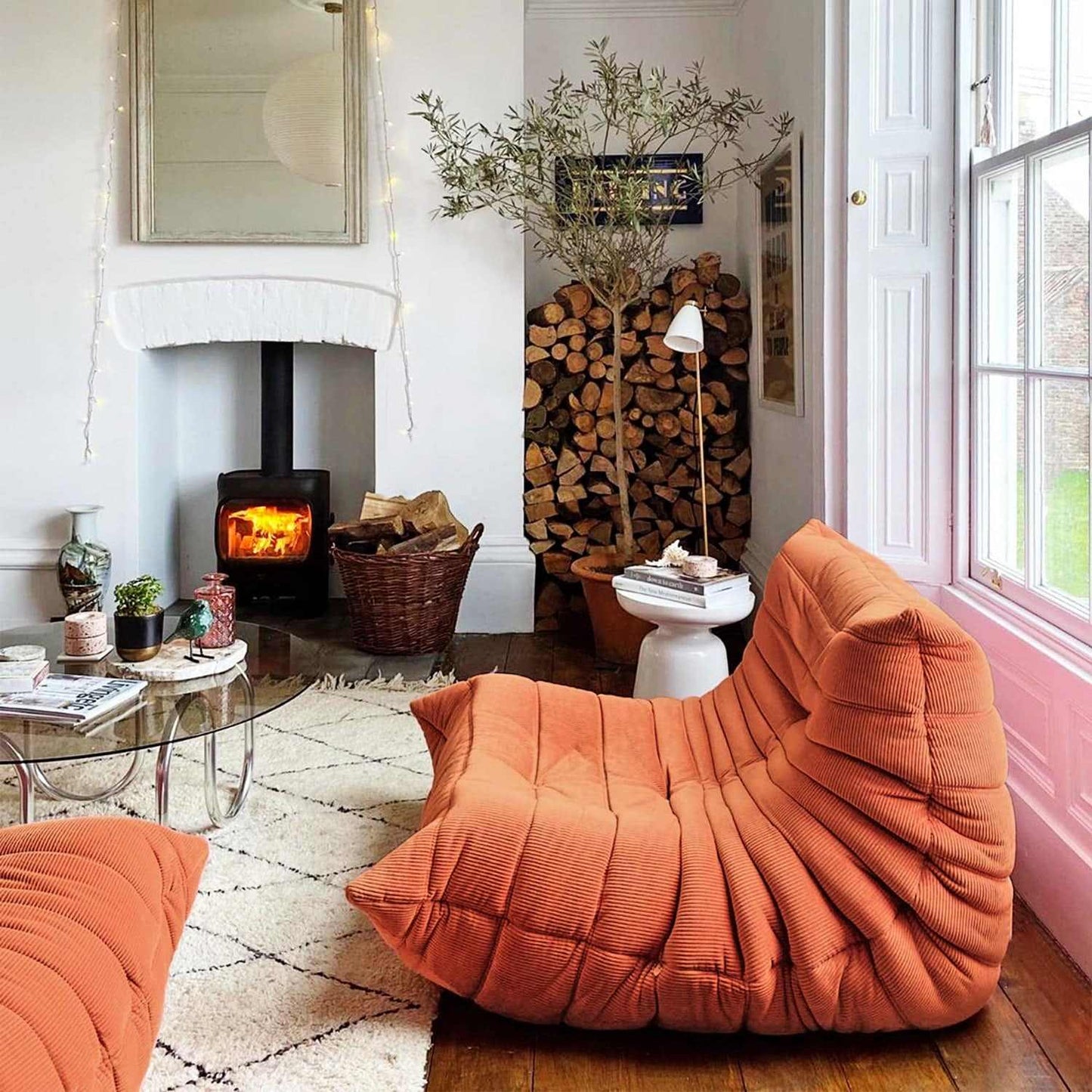 Orange suede armchair and ottoman set in cozy living room with fireplace