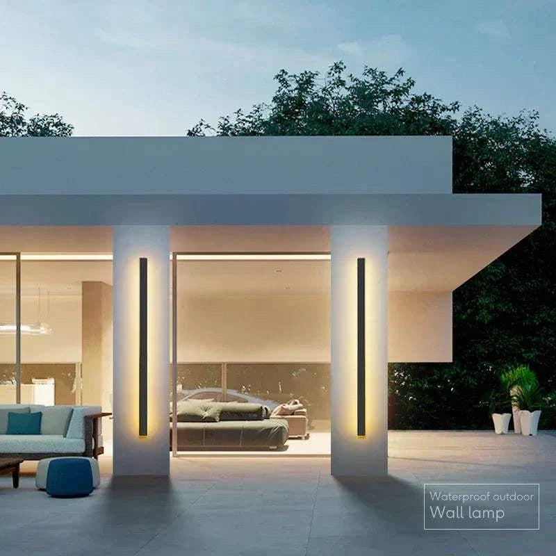 Modern waterproof IP65 outdoor wall light with sleek black aluminum body illuminating front door and patio area